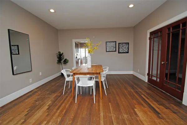 a dining room with furniture and wooden floor