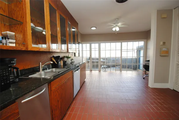 a kitchen with stainless steel appliances granite countertop a sink counter space and cabinets