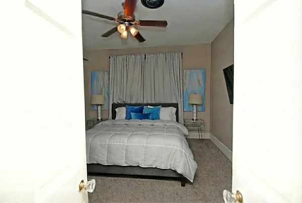 a bedroom with a bed and a chandelier