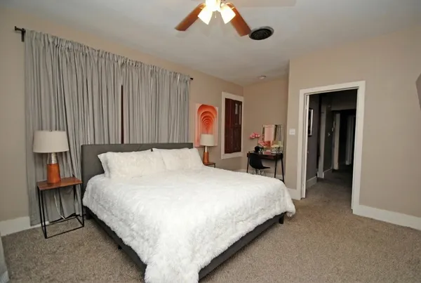 a large bedroom with bed and window