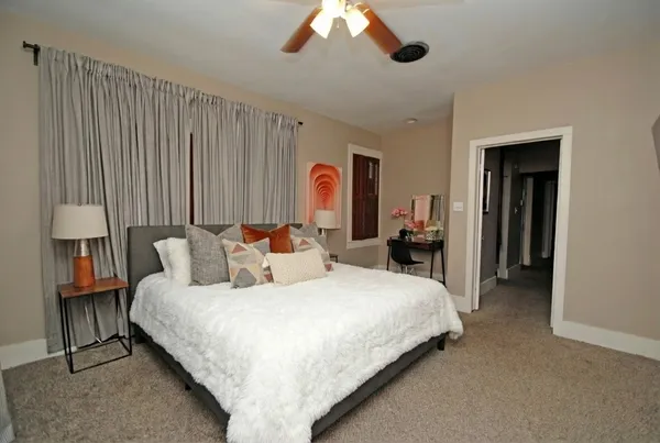 a bedroom with bed and a chandelier