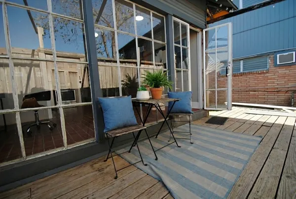 a balcony with table and chairs