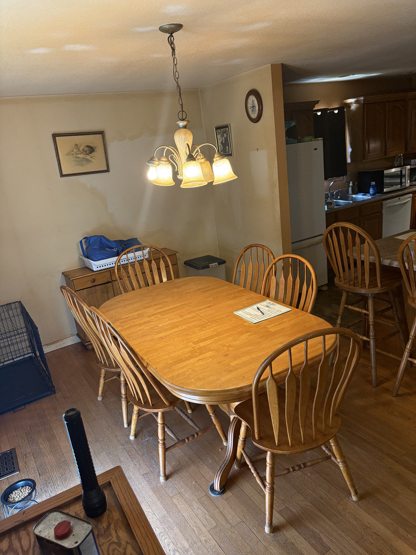 1003 Cyndy Lane Champaign, IL 61822 - Photo 12 of 25 a outdoor dining space with furniture and chandelier