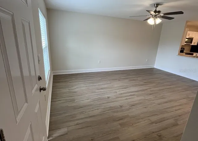 wooden floor in an empty room with a window