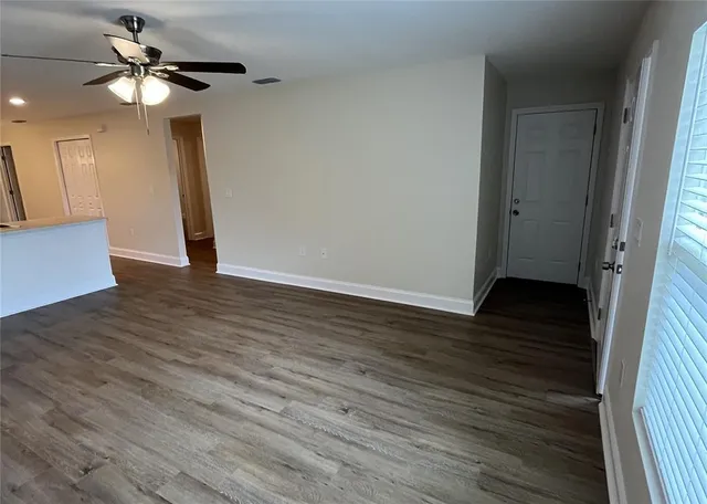 a view of an empty room with wooden floor
