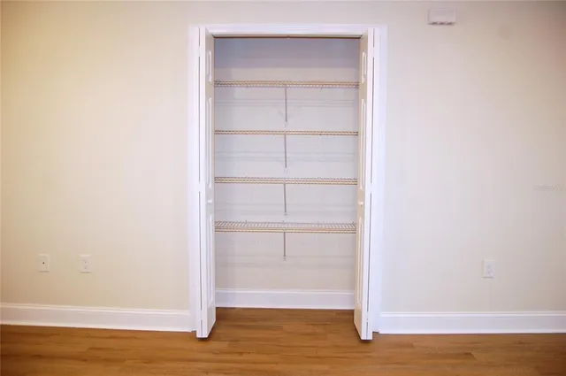 a view of a room with wooden floor