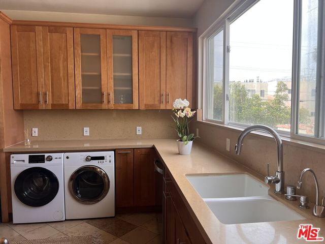 a utility room with sink dryer and washer