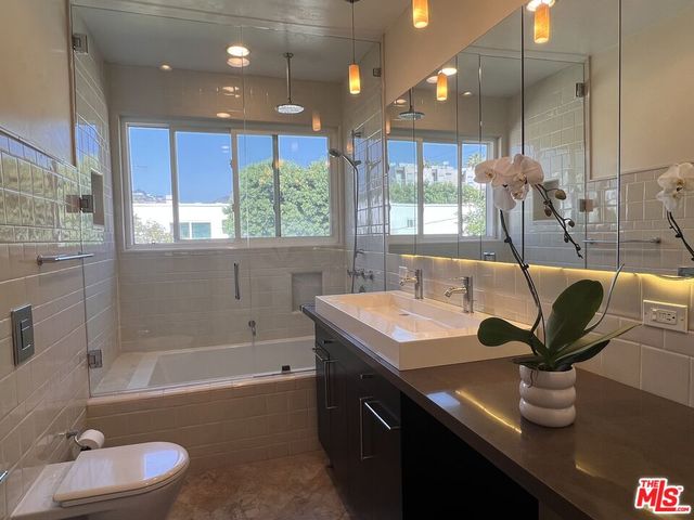 a bathroom with a sink a bathtub and a window