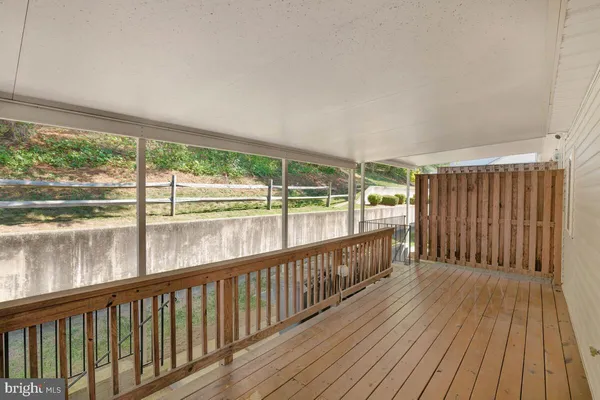 a view of a balcony with wooden floor