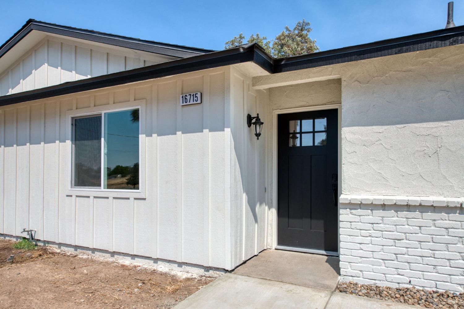 16715 Monreal Road Madera, CA 93636 - Photo 11 of 39 a view of a house with a door