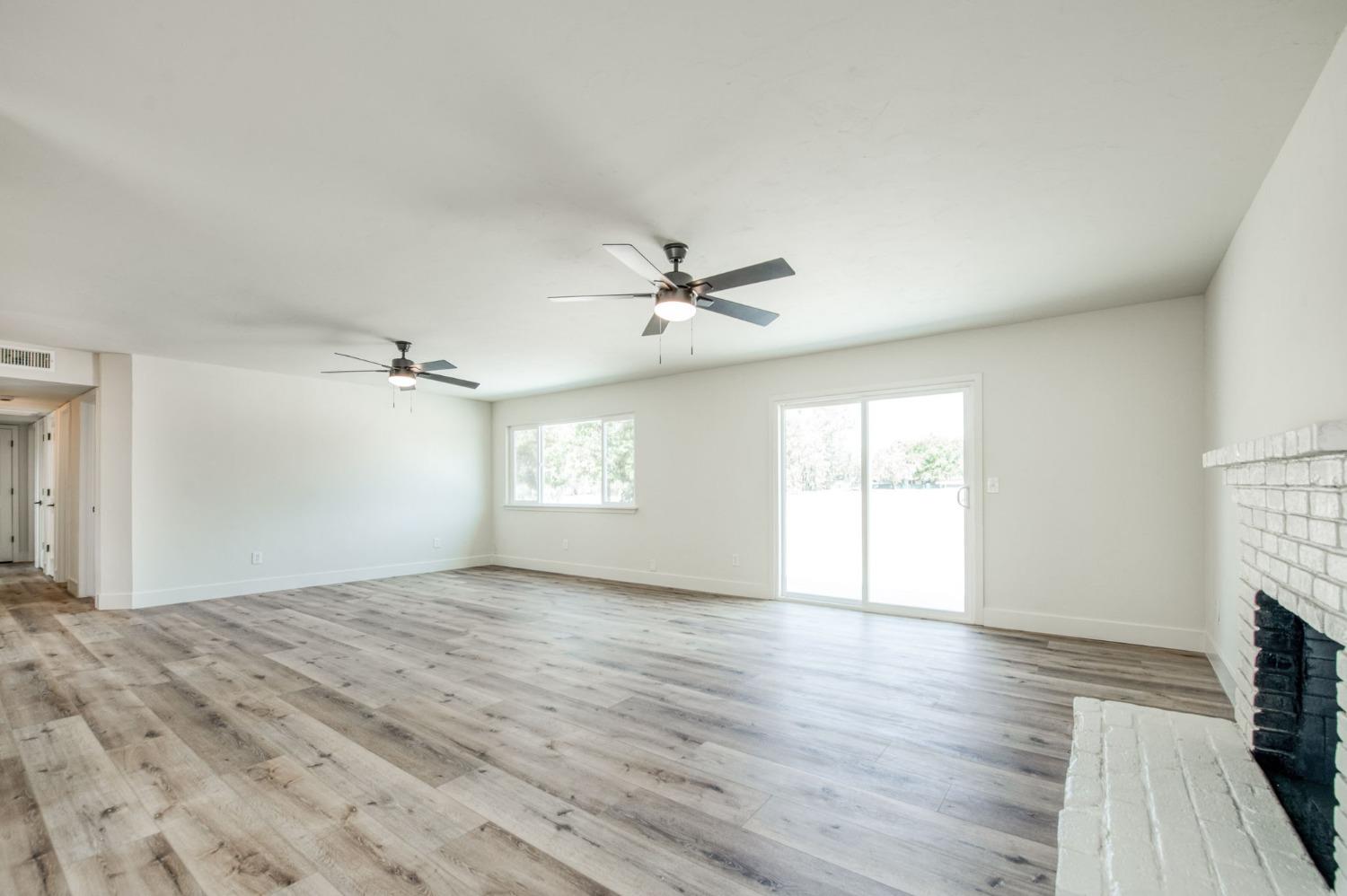 16715 Monreal Road Madera, CA 93636 - Photo 13 of 39 wooden floor in an empty room with a window
