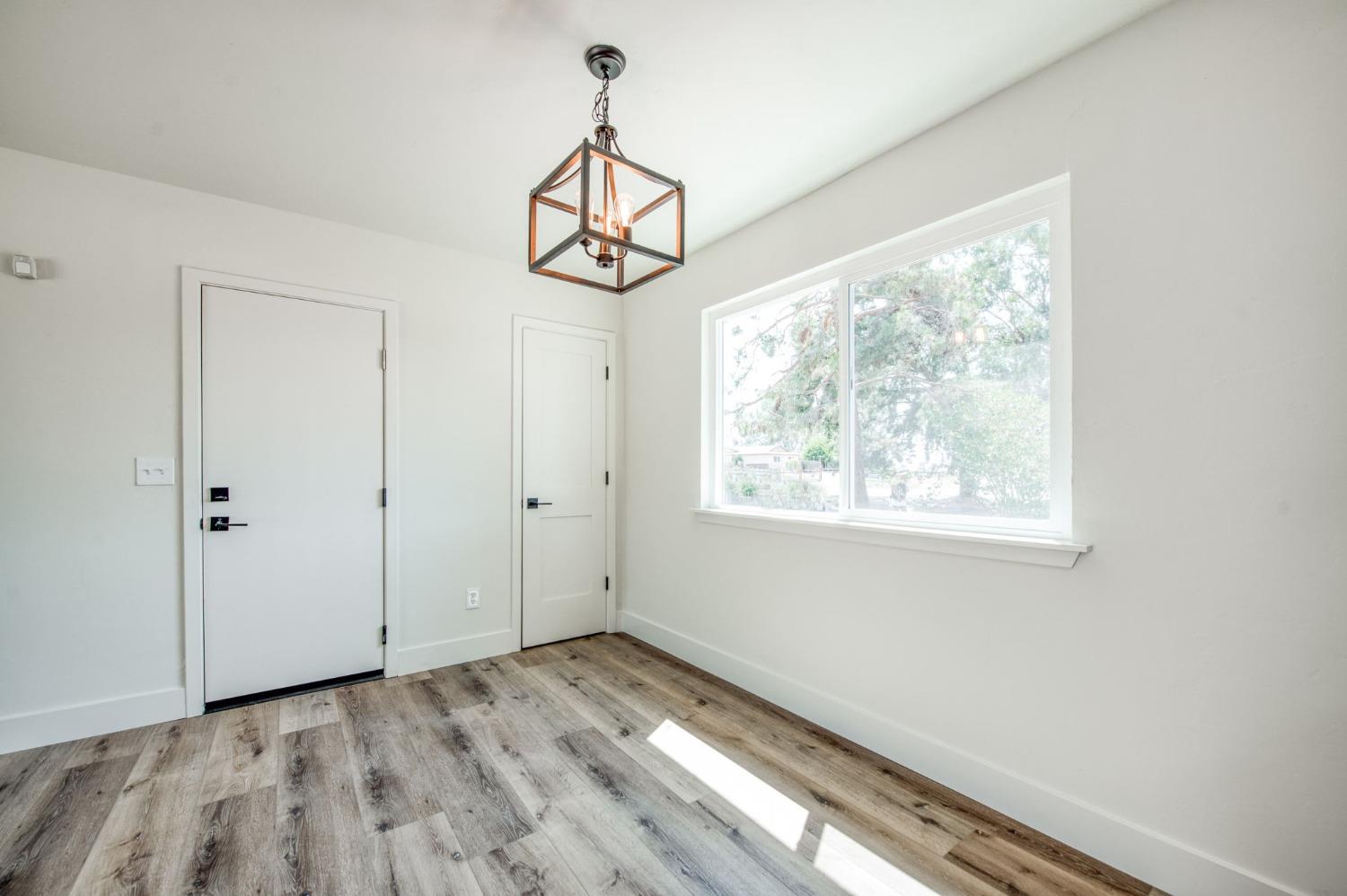 16715 Monreal Road Madera, CA 93636 - Photo 18 of 39 a view of a hallway with a chandelier