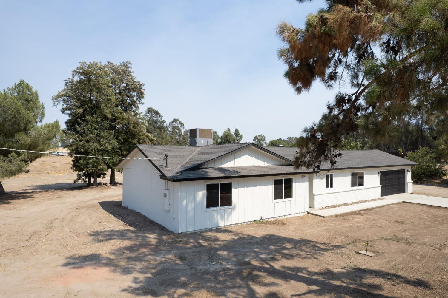 16715 Monreal Road Madera, CA 93636 - Photo 24 of 39 a front view of a house with a yard