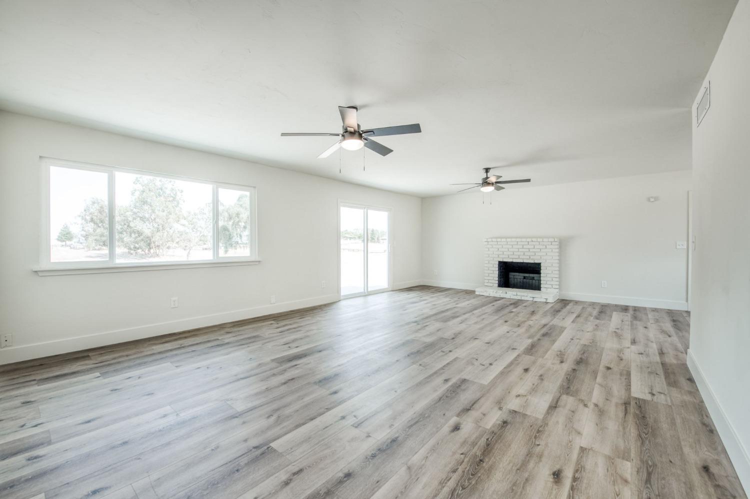 16715 Monreal Road Madera, CA 93636 - Photo 3 of 39 a view of empty room with wooden floor and fan