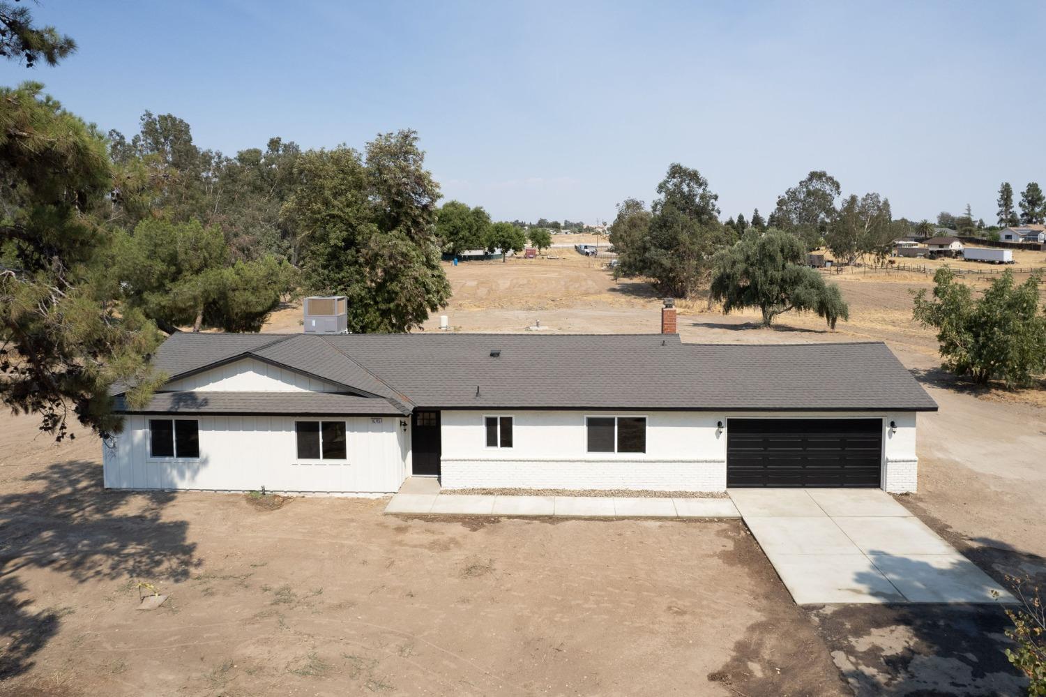 16715 Monreal Road Madera, CA 93636 - Photo 37 of 39 a house that has a tree in front of it