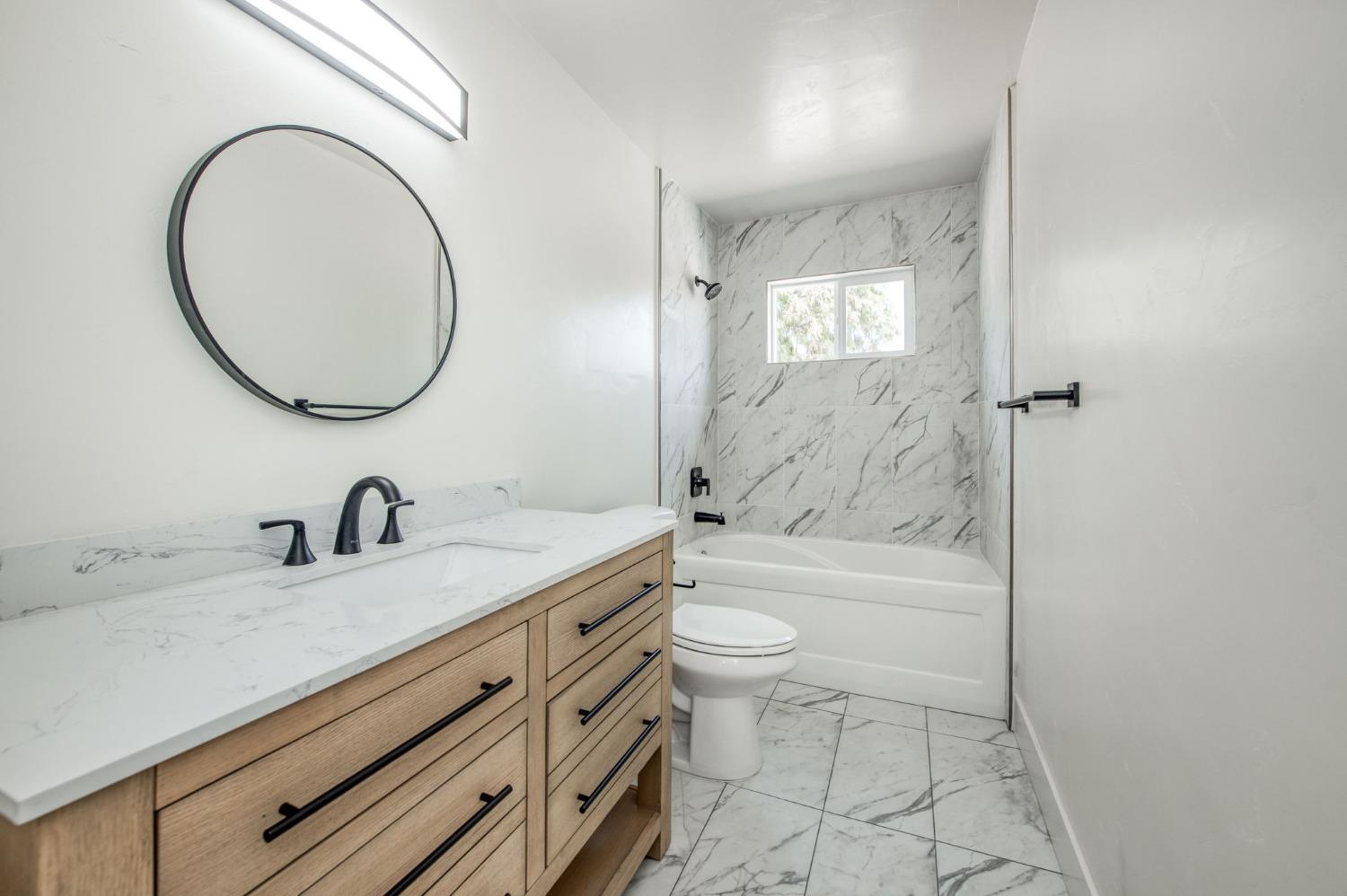 16715 Monreal Road Madera, CA 93636 - Photo 8 of 39 a bathroom with a sink a toilet and a mirror