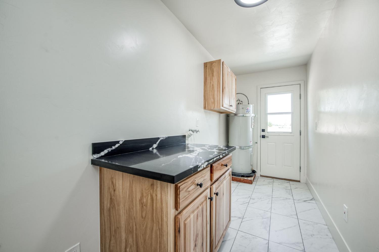 16715 Monreal Road Madera, CA 93636 - Photo 9 of 39 a utility room with dryer and washer