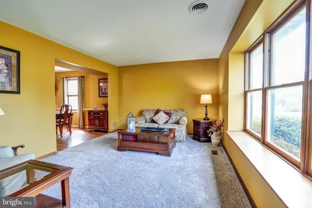 a living room with furniture and large windows