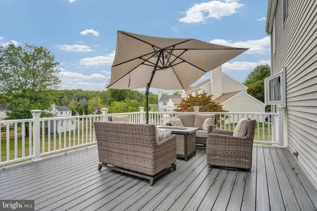 a view of a roof deck with a table and chairs