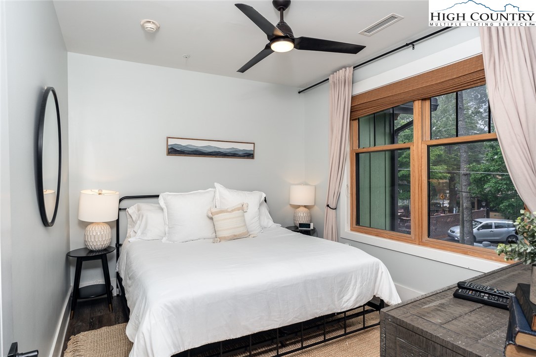 1150 Main Street, Unit DOGWOOD Blowing Rock, NC 28605 - Photo 13 of 26 a bedroom with a large bed and a large window