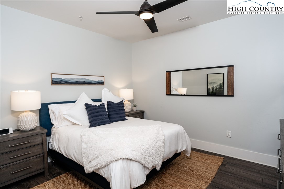 1150 Main Street, Unit DOGWOOD Blowing Rock, NC 28605 - Photo 22 of 26 a bedroom with bed and painting on the wall