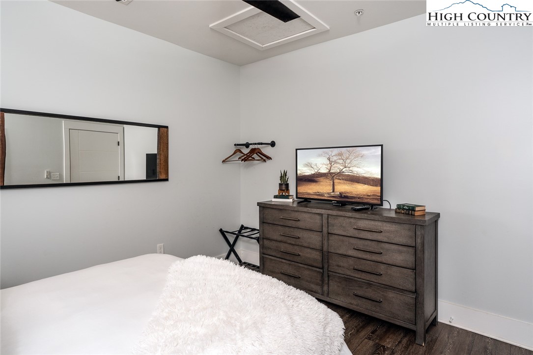 1150 Main Street, Unit DOGWOOD Blowing Rock, NC 28605 - Photo 23 of 26 a bed room with a bed and a dresser