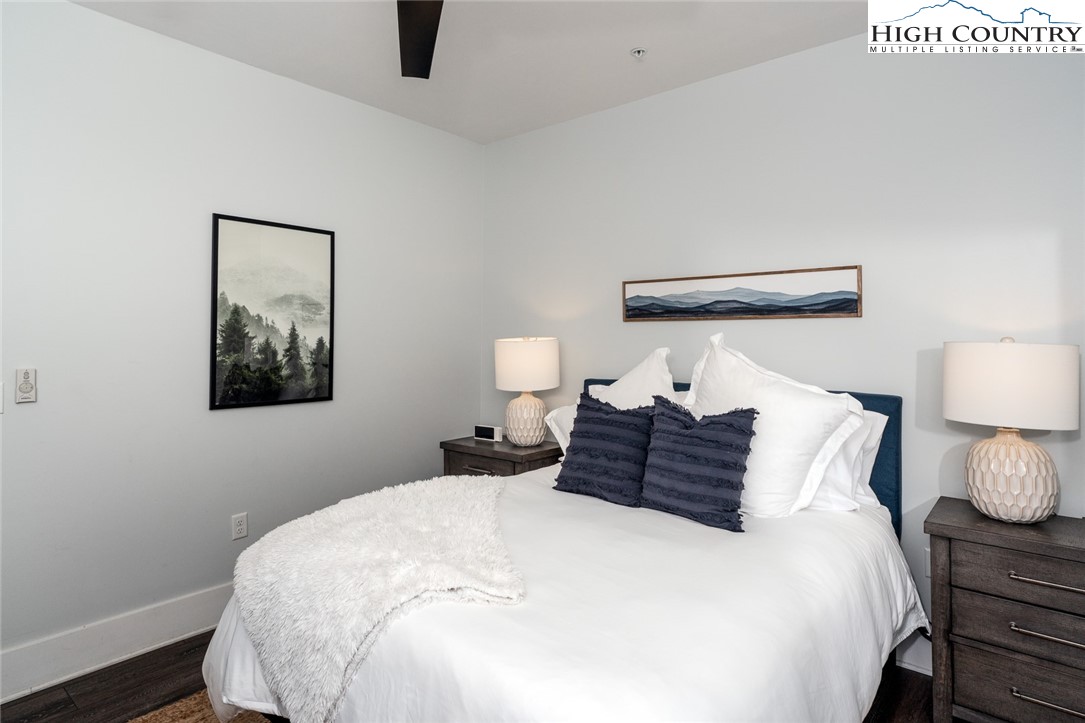 1150 Main Street, Unit DOGWOOD Blowing Rock, NC 28605 - Photo 25 of 26 a bedroom with a bed and wooden floor