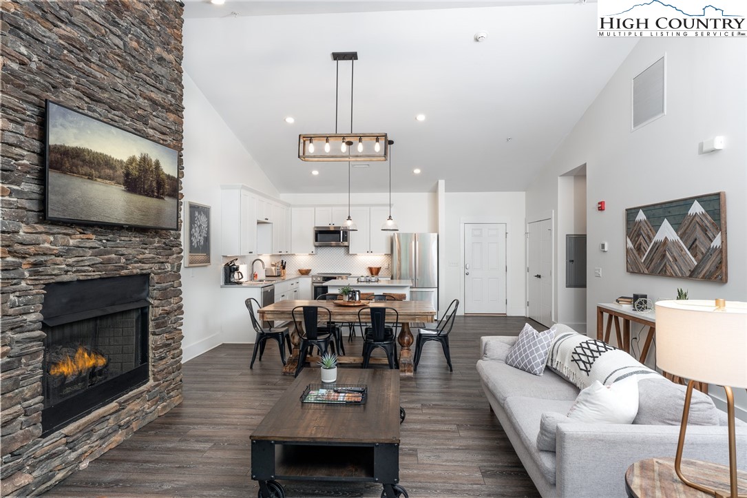 1150 Main Street, Unit DOGWOOD Blowing Rock, NC 28605 - Photo 4 of 26 a living room with furniture a fireplace and a flat screen tv