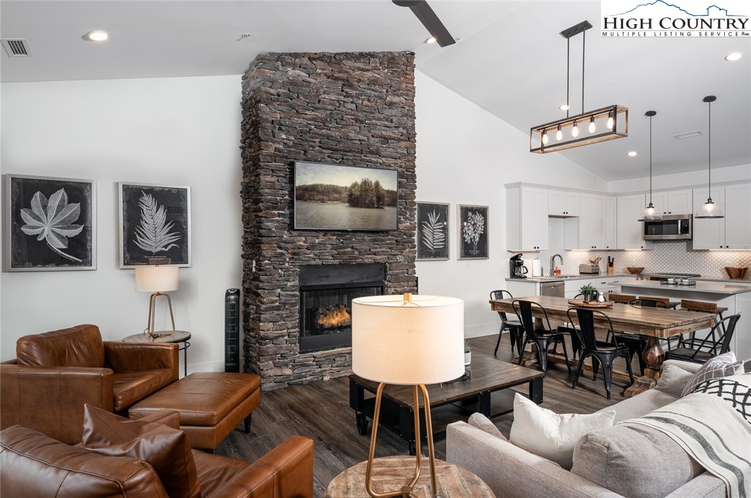 1150 Main Street, Unit DOGWOOD Blowing Rock, NC 28605 - Photo 6 of 26 a living room with furniture a fireplace and a flat screen tv