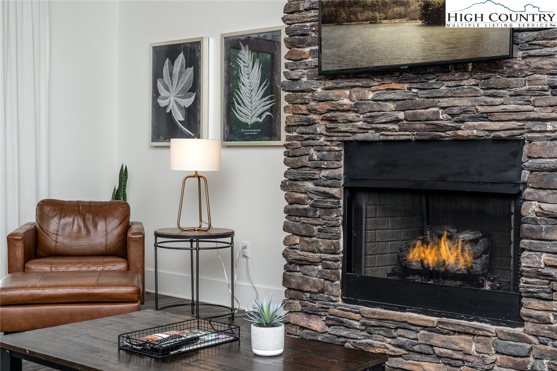 1150 Main Street, Unit DOGWOOD Blowing Rock, NC 28605 - Photo 7 of 26 a living room with furniture a fireplace and a flat screen tv