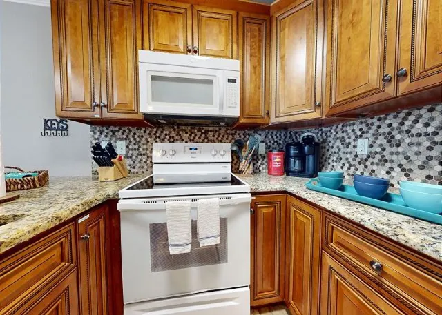 a kitchen with stainless steel appliances granite countertop a sink and cabinets