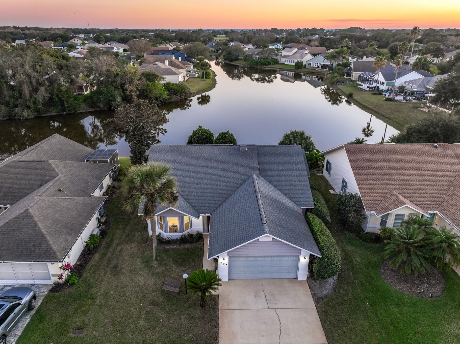 Aerial view at dusk of a water view and a residential view