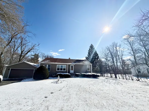 a view of house with a yard covered in snow
