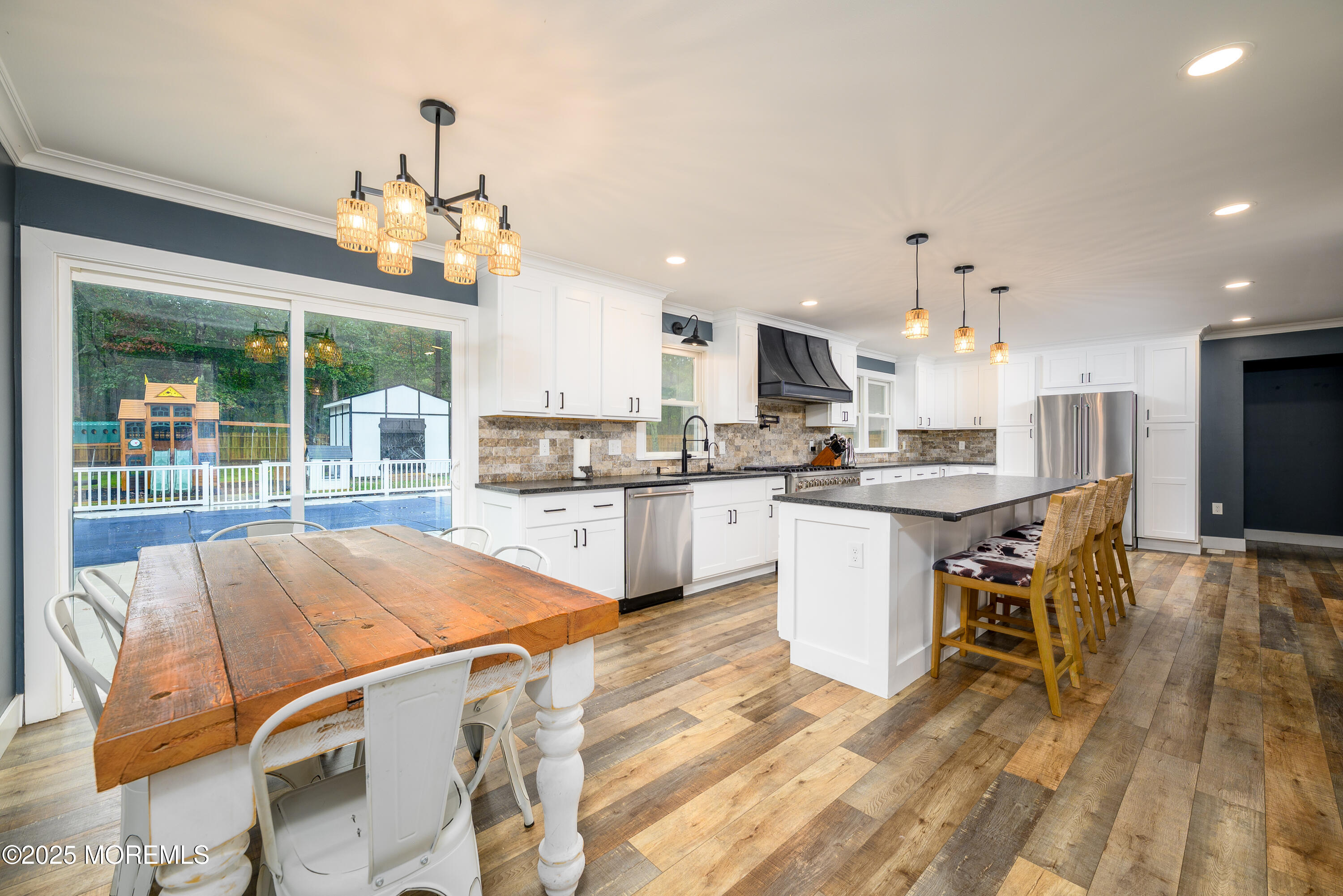 453 Stage Road Little Egg Harbor, NJ 08087 - Photo 31 of 52 a kitchen with a table chairs refrigerator and microwave