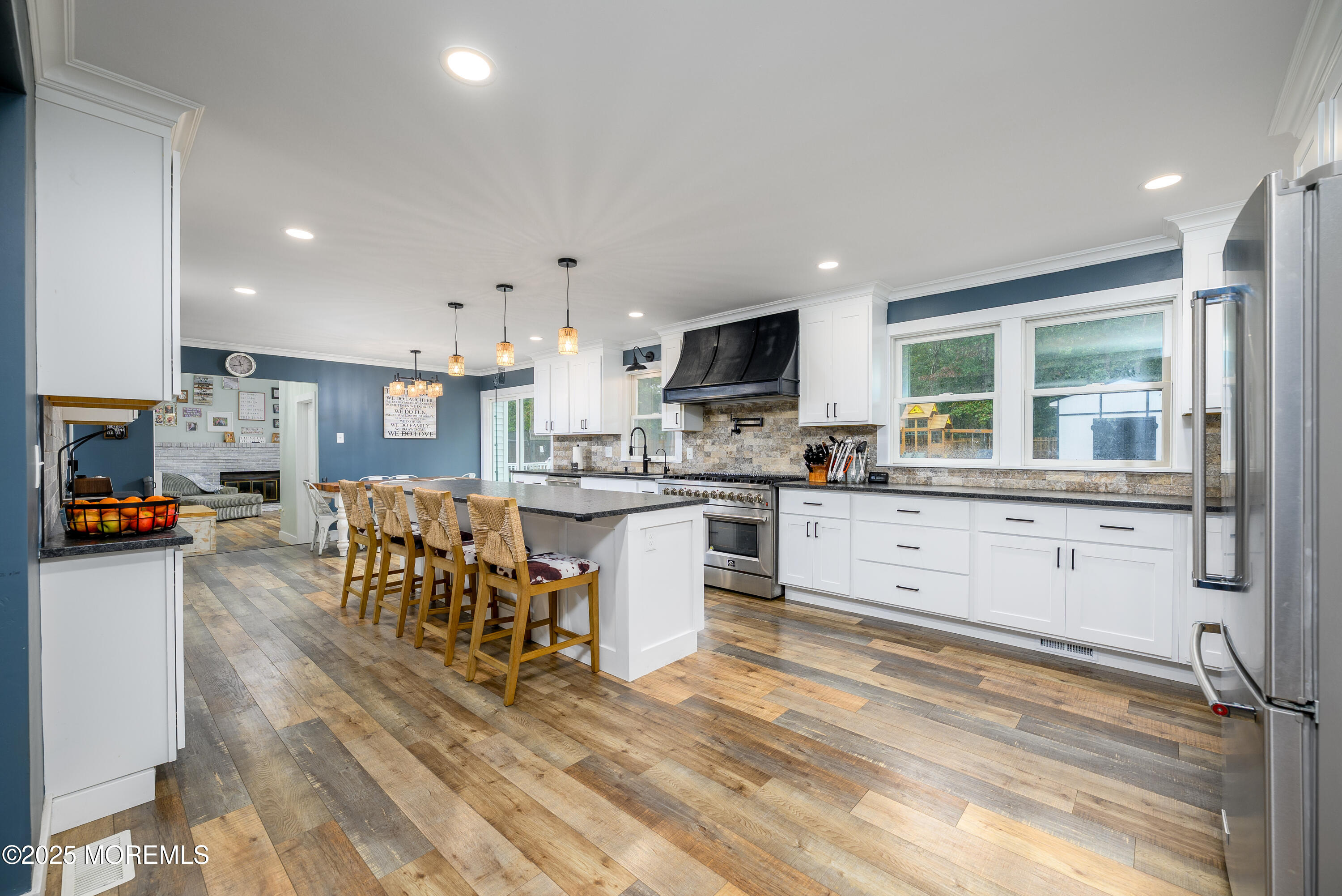 453 Stage Road Little Egg Harbor, NJ 08087 - Photo 35 of 52 a kitchen with stainless steel appliances kitchen island granite countertop a refrigerator a stove a sink a dining table and chairs with wooden floor