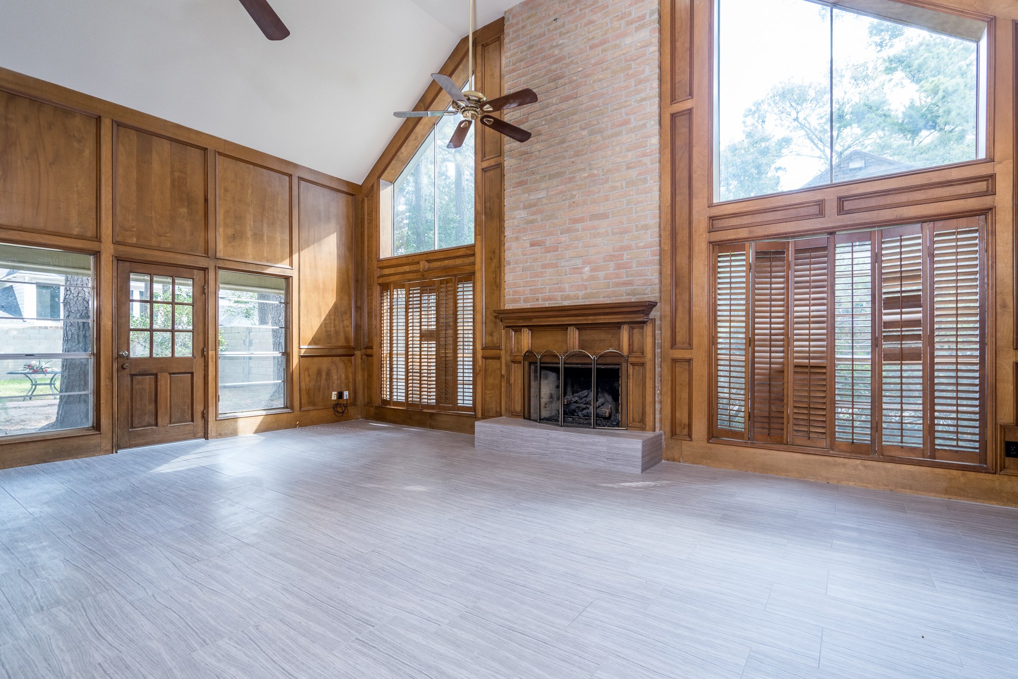 an empty room with wooden floor and fireplace