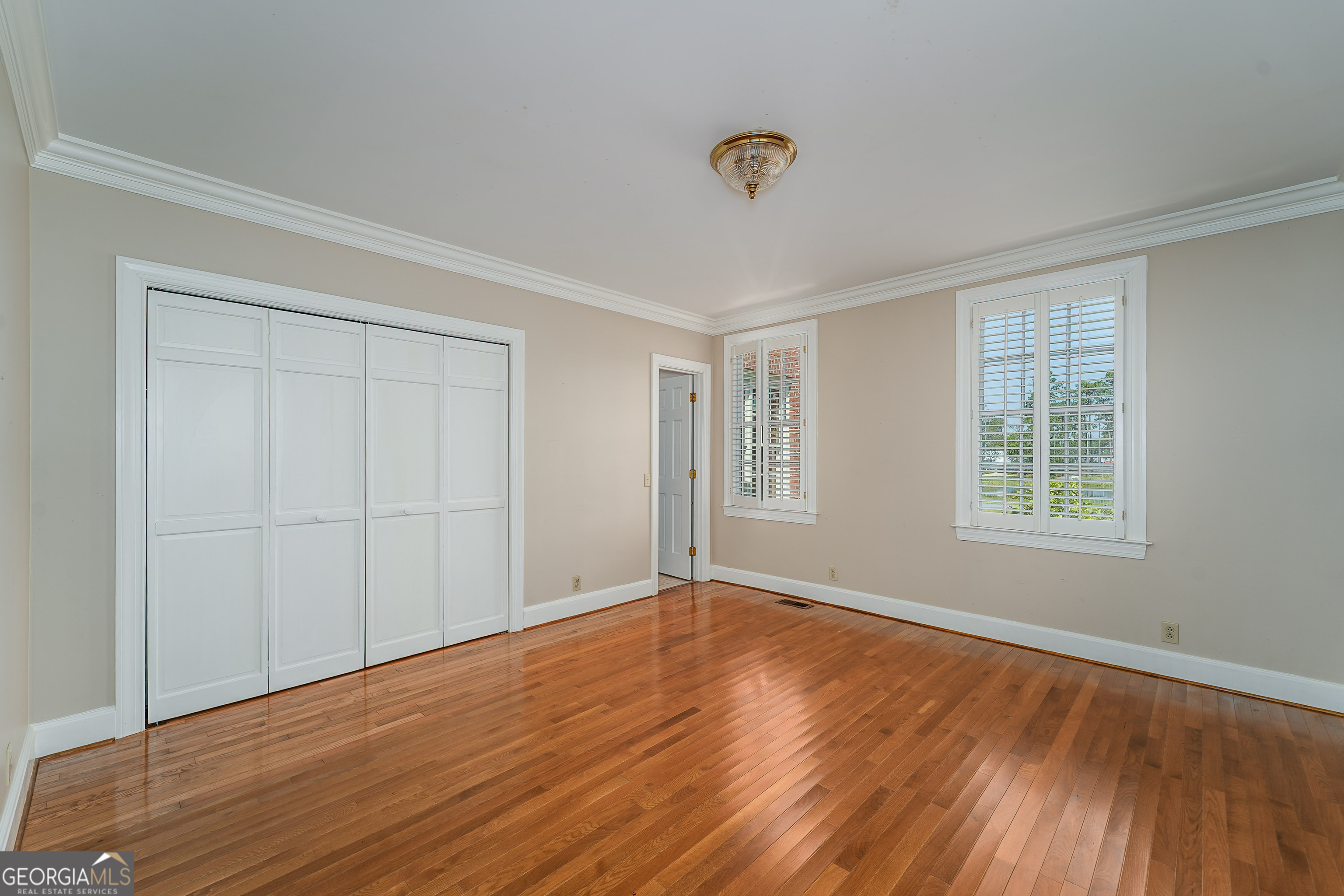 1602 Ward St Extension West Douglas, GA 31533 - Photo 39 of 70 a view of an empty room with wooden floor and a window