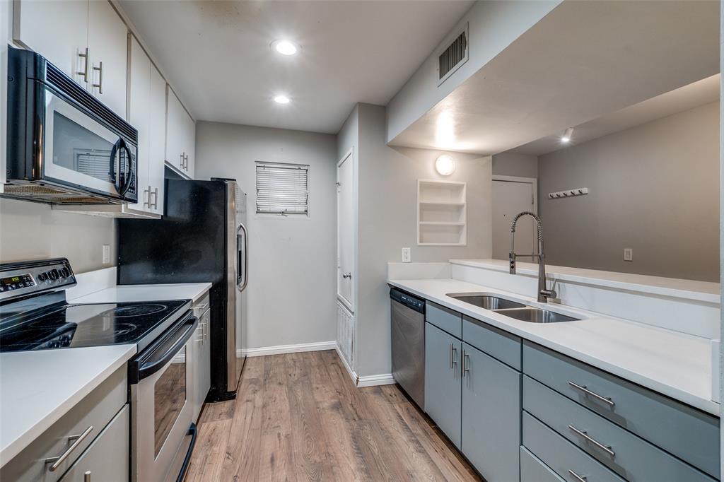 4231 Travis Street, Unit 20 Dallas, TX 75205 - Photo 11 of 23 a kitchen with a sink stainless steel appliances a sink and cabinets