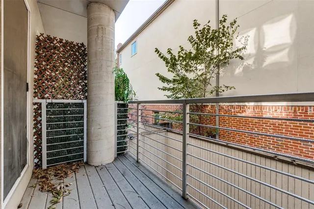 a view of a balcony with wooden floor
