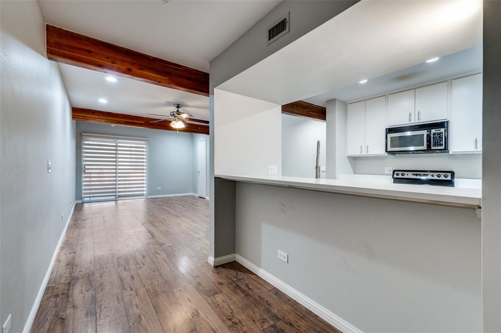 4231 Travis Street, Unit 20 Dallas, TX 75205 - Photo 8 of 23 a kitchen with stainless steel appliances a refrigerator and a stove top oven