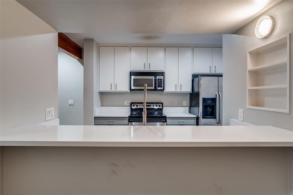 4231 Travis Street, Unit 20 Dallas, TX 75205 - Photo 9 of 23 a kitchen with stainless steel appliances a sink and a refrigerator