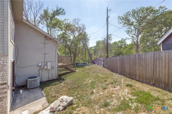 an aerial view of a house with a yard and lake view