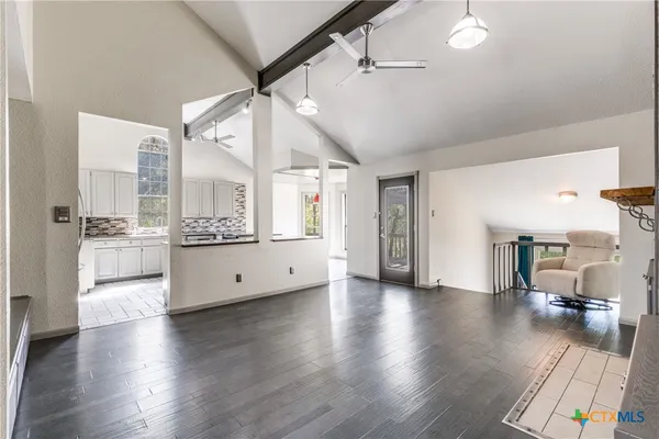 a kitchen with stainless steel appliances granite countertop a sink and a refrigerator