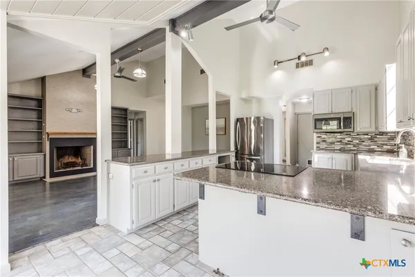a large kitchen with granite countertop a sink and dishwasher with a large window