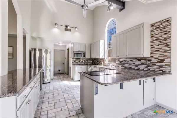 an empty room with wooden floor a fireplace and window