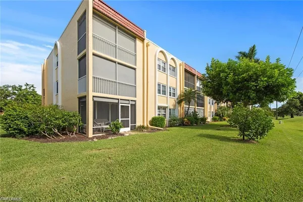 a view of a big yard with lawn chairs