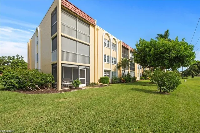 a view of a big yard with lawn chairs
