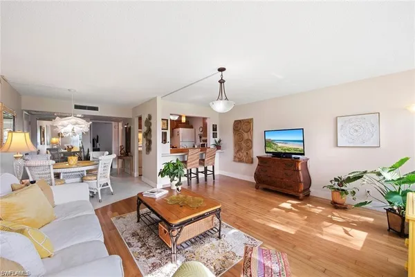 a living room with furniture a rug and a window