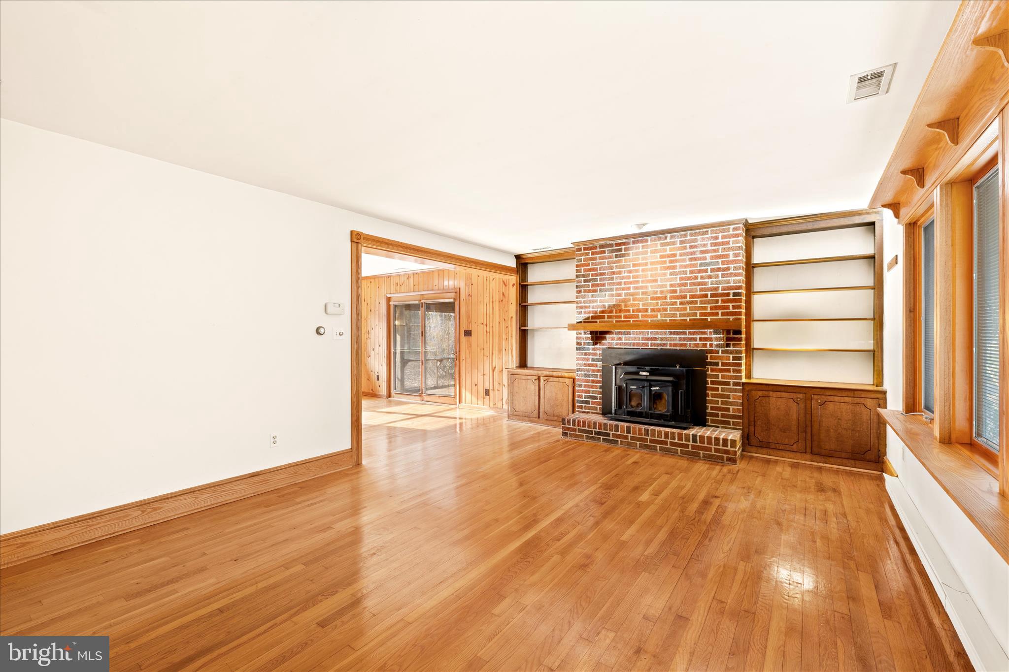 4170 Coulbourn Mill Road Salisbury, MD 21804 - Photo 11 of 47 a view of an empty room with wooden floor fireplace and a window