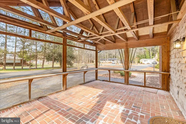 a view of a porch with wooden floor and iron stairs